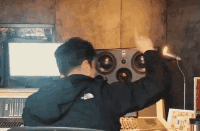 a man wearing a black jacket with the north face logo on the back is dancing