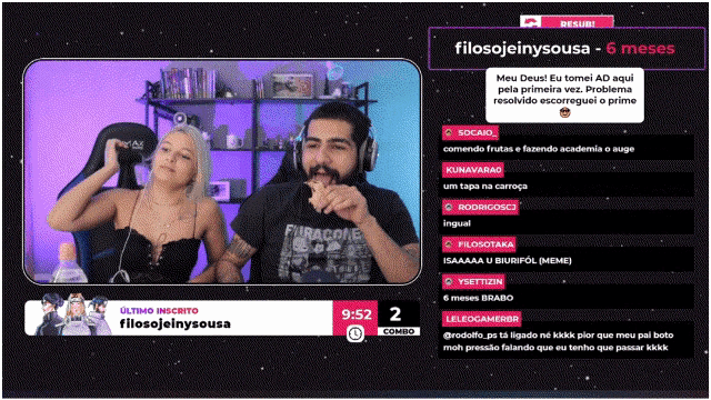 a man and a woman are sitting in front of a screen that says filosojeinysousa
