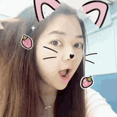 a woman wearing a cat ear headband with stickers on her face