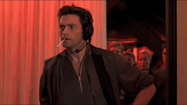 a man wearing headphones smoking a cigarette
