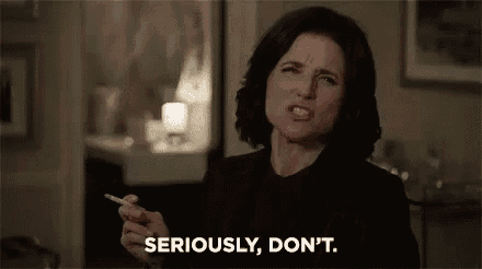 a woman is smoking a cigarette and saying `` seriously , do n't '' .