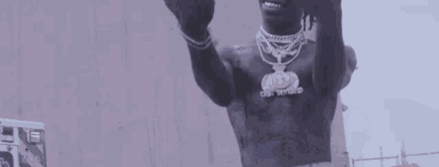 a man with a lot of necklaces on his neck