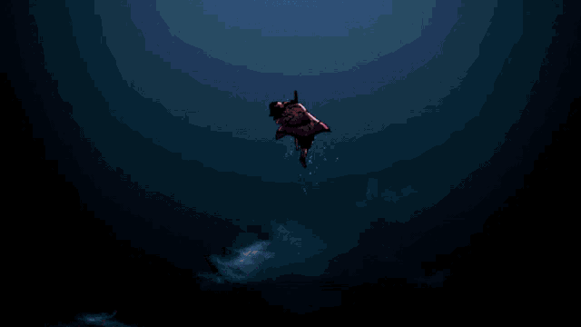 a silhouette of a person floating in the water