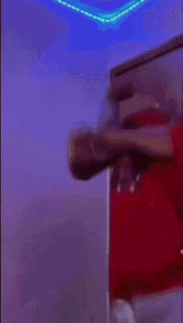 a person in a red dress is standing in a room
