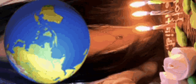 a drawing of a globe surrounded by candles that says ' i love you ' on them