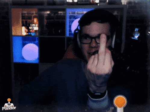 a man with glasses giving the middle finger in front of a pandora logo