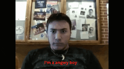 a man says i 'm a angwy boy in front of a wall of pictures