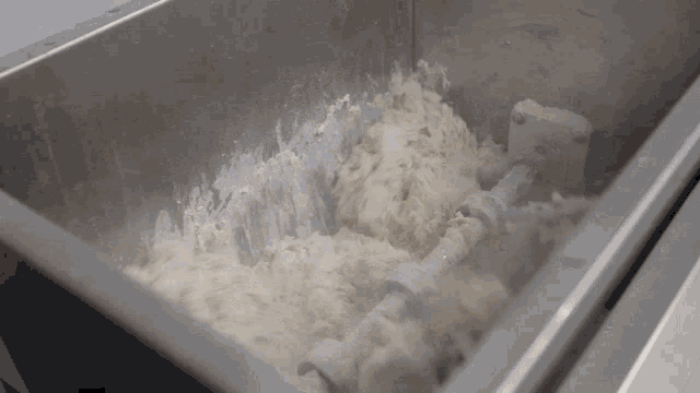 a stainless steel container filled with a thick white substance