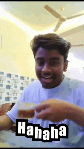 a man in a white shirt is holding a glass with the word ' hahaha ' on the bottom right