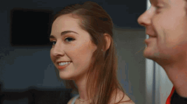 a man and a woman are smiling at each other