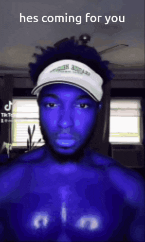 a man with blue skin is wearing a white hat and has the words hes coming for you on his chest .