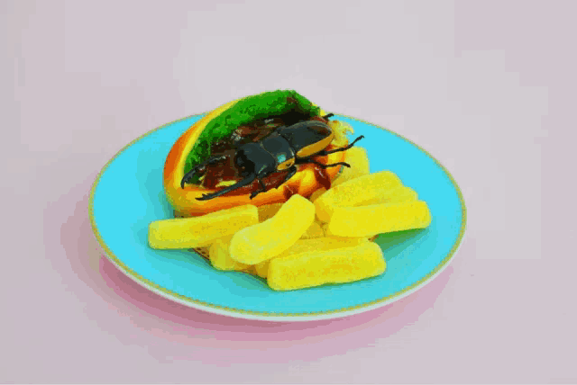 a blue plate with french fries and a rainbow colored hot dog