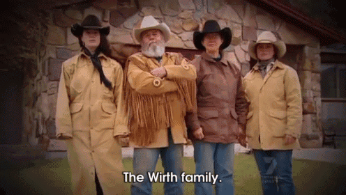 a group of people standing in front of a stone building with the words " the wirth family " on the bottom
