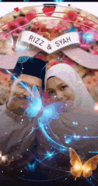 a man and a woman are posing for a picture with a banner that says rizz & syah