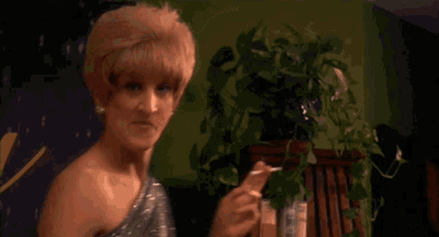 a woman is smoking a cigarette and asking for one drink
