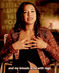 a woman in a wheelchair is holding her breasts and saying and my breasts ache with rage .