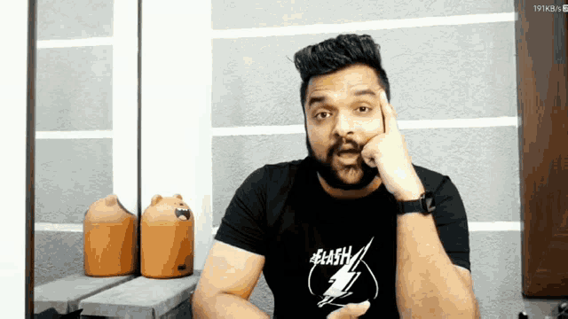 a man wearing a black shirt with a lightning bolt on it