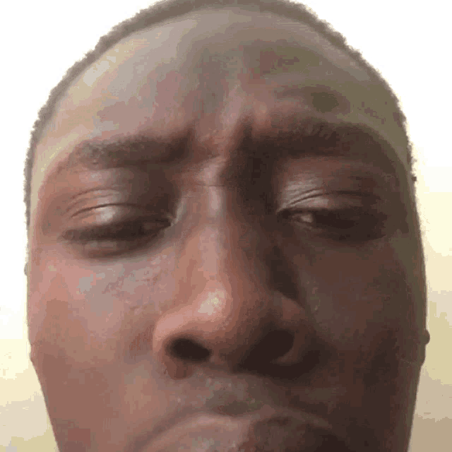 a close up of a man 's face with closed eyes