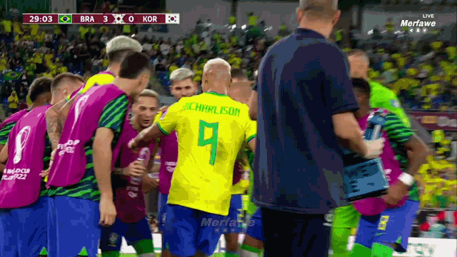 a group of soccer players are huddled together and one of them has the number 9 on his jersey