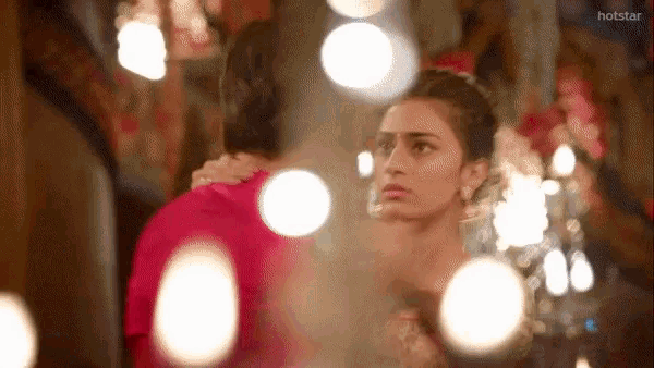a blurred image of a man and woman with the words hotstar on the bottom right