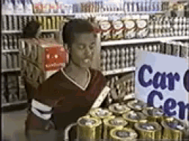 a woman in a red shirt is standing in front of a sign that says car center .