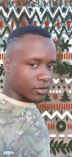 a man in a camo shirt is standing in front of a screen that says techno pops