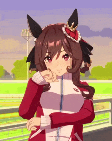 a girl in a red and white jacket is standing on a race track with her hands on her chin .