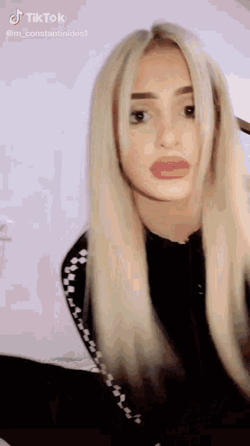 a woman with long blonde hair has a tiktok account