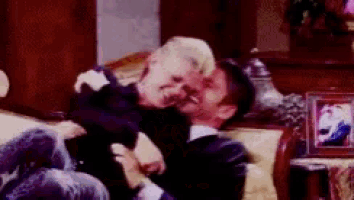 a man kisses a little girl on the cheek