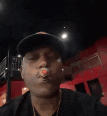a man wearing a hat is smoking a cigar