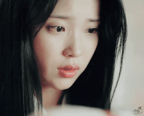a close up of a woman 's face with the word lily on the bottom left