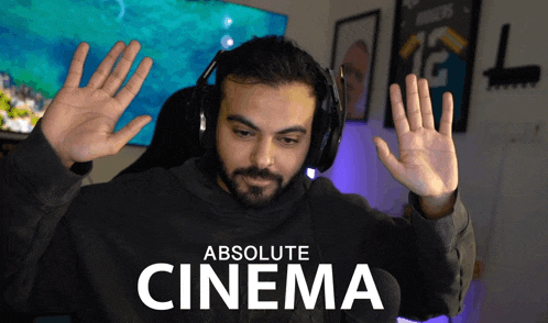 a man wearing headphones says absolute cinema