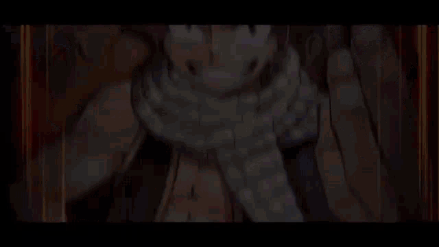 a close up of a person 's face with a scarf around their neck in a video game .