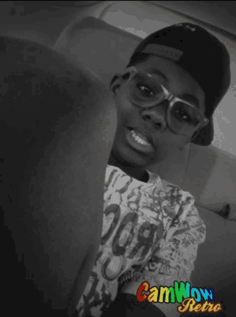 a boy wearing glasses and a hat with camwow retro on the bottom right