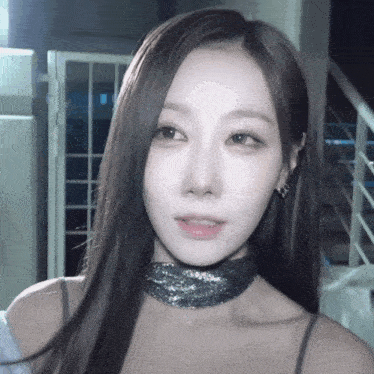 a close up of a woman wearing a choker