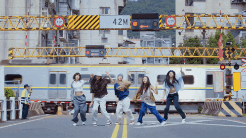 a group of people are dancing in front of a sign that says 42m on it