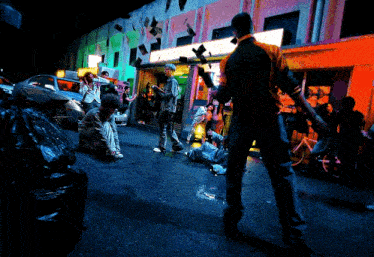 a group of people are gathered outside of a building that says ' a & a ' on it