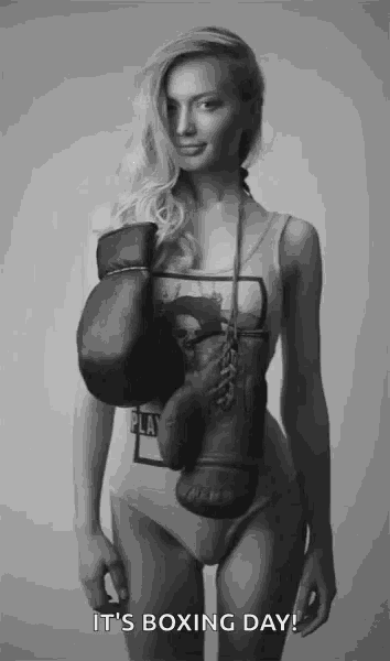 a woman wearing boxing gloves with the words it 's boxing day below her