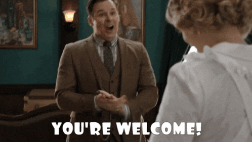 a man in a suit and tie says you 're welcome to a woman