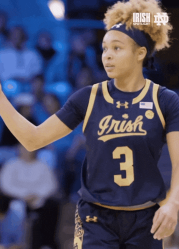 a female basketball player wearing a jersey that says irish 3