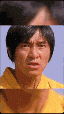 a close up of a man 's face in a yellow shirt
