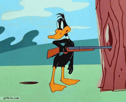 a cartoon of daffy duck holding a gun and aiming it at a tree