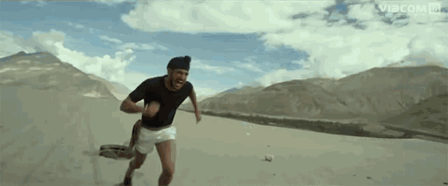 a man running in the desert with vibcom on the bottom