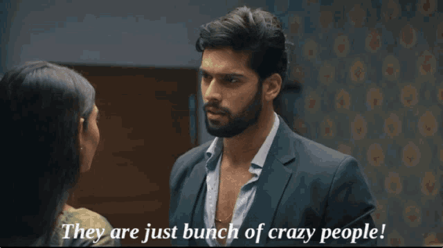 a man in a suit talks to a woman with the words they are just bunch of crazy people