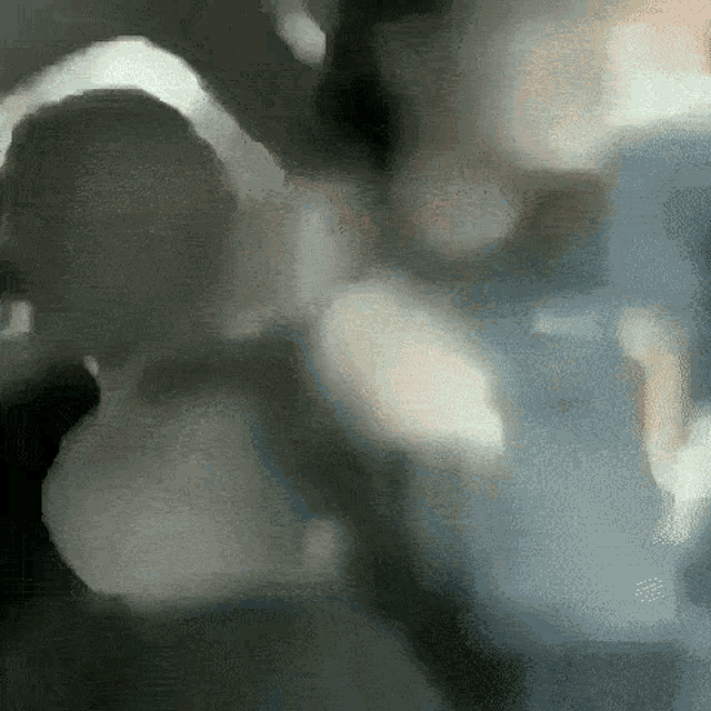 a blurry picture of a person 's face and a blurred background