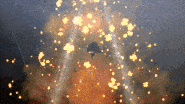 a jet is flying through a huge explosion of fire