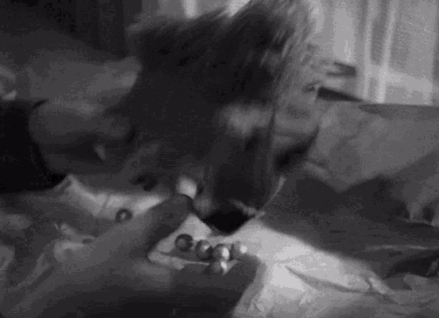 a black and white photo of a person laying on a table