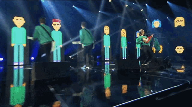 a group of people standing on a stage with cartoon faces on them