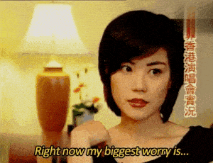 a woman in a black dress is standing in front of a lamp and says `` right now my biggest worry is ... ''