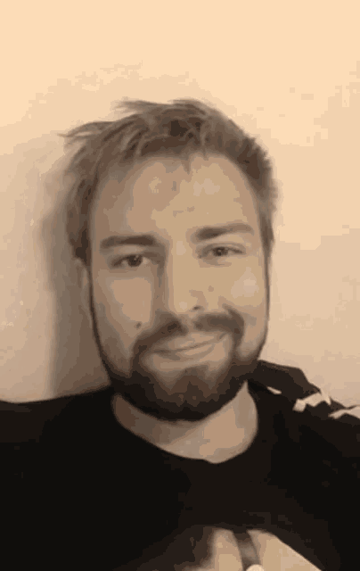 a man with a beard is wearing a black shirt with a picture of a banana on it